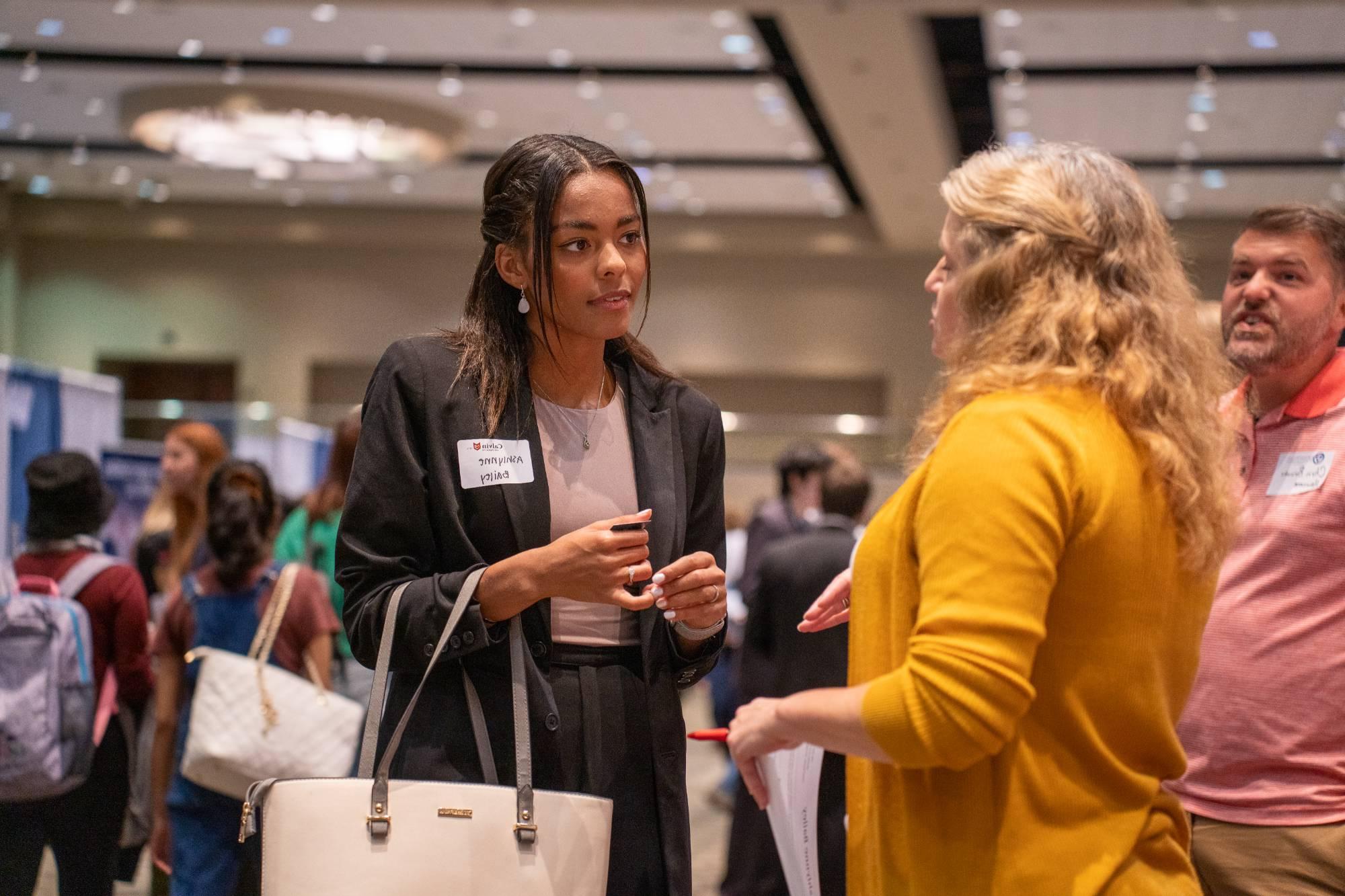 people talking at career fair